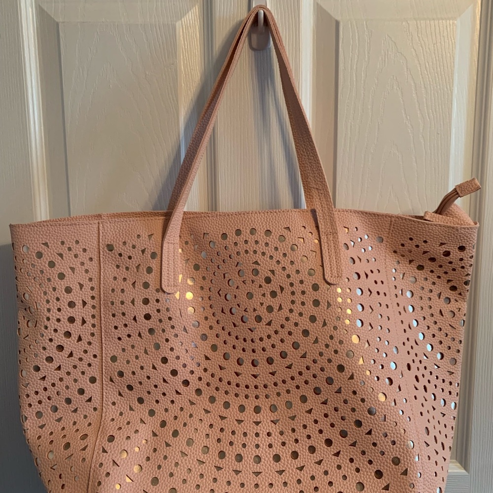 NWT. Cannot tell the brand though.  Light pink and gold under cutouts.